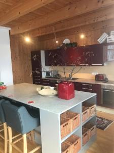 a kitchen with a counter with a table and chairs at Skiblickhaus in Russbach am Pass Gschütt