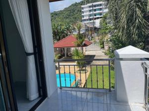 a balcony with a view of a swimming pool at Kata Sea Blue Villa in Kata Beach