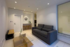 a living room with a couch and a table at City Napa Seaview Villas - Villa 7 in Ayia Napa