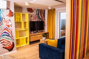 a living room with a couch and a television at Ljubljana Urban Apartments - Quiet Stay & Free Parking in Ljubljana