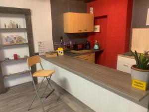 a kitchen with a counter and a chair in it at melissa in Wittingen