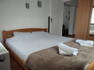a bedroom with a bed with towels on it at Apartman Jevtic Zlatibor in Zlatibor