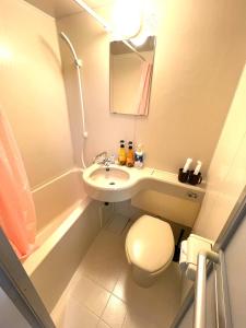 a small bathroom with a toilet and a sink at Tokyo Stay Waseda in Tokyo