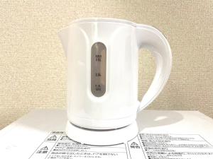 a white blender sitting on top of some receipts at Tokyo Stay Waseda in Tokyo