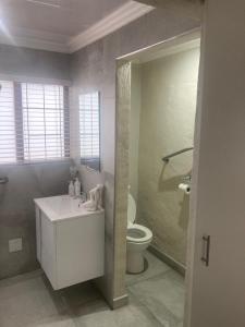 ein Badezimmer mit einem weißen Waschbecken und einem WC in der Unterkunft Tinroofs Cottage in Kelso