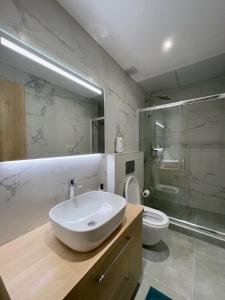 a bathroom with a sink and a shower and a toilet at Stunning 2 BR Near Acropolis in Athens