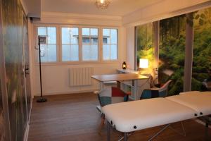 een kamer met een bed, een tafel en een raam bij Résidence Loanie & Soins in Châlus
