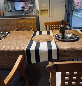 a table with a bottle of wine on top of it at Orotava The Home - Vacational rental with the lifestyle of 1700 and the comfort of 2022 in La Orotava