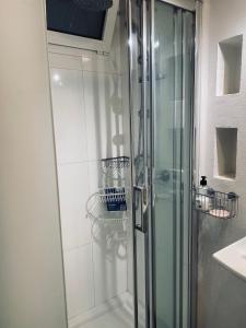 a shower with a glass door in a bathroom at Orotava The Home - Vacational rental with the lifestyle of 1700 and the comfort of 2022 in La Orotava