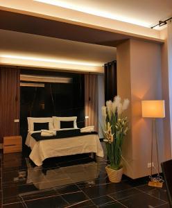 a bedroom with a large bed and a lamp at Emma Hotel Bologna Fiera in Bologna