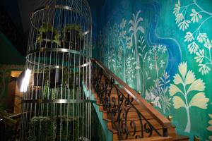 a staircase with a bird cage on the wall at Kandy Dendrobium House in Kandy +114 photos