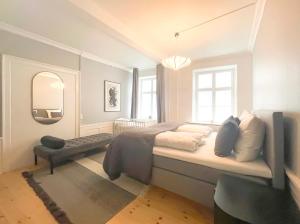 a bedroom with a large bed and a mirror at Homely Apartment by CPH Canals in Copenhagen +21 photos