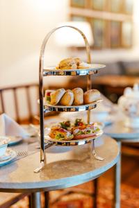 a three tiered tray of food on a table at Kandy Dendrobium House in Kandy