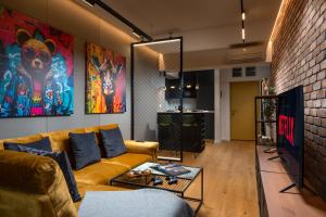 sala de estar con sofá y pared de ladrillo en Brooklyn Studio - Aviatiei Park - Netflix - Parking, en Bucarest