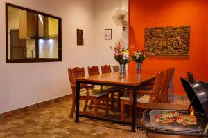 a dining room with a wooden table and chairs at Pattaya Hill close to Walking St and City in Nong Prue