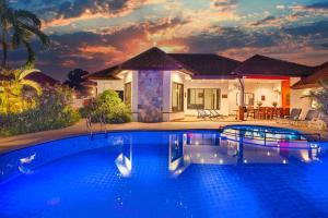 a swimming pool in front of a house at Pattaya Hill close to Walking St and City in Nong Prue