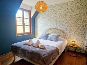 a bedroom with a bed with two pillows on it at Le Panoramique in Barneville-Carteret +44 photos