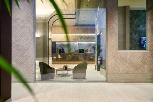 a lobby with two chairs and a table at VP Madroño in Madrid