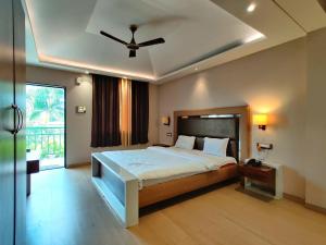 a bedroom with a large bed with a ceiling fan at The Kanila Resort in Karjat +25 photos