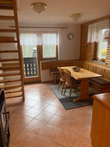 a dining room with a wooden table and chairs at Apartments Nune in Zreče