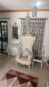 a white chair sitting in a room with a mirror at Arsya Bagas Villa in Bogor