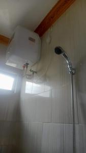 een douche in een badkamer met een douchekop bij Arsya Bagas Villa in Bogor