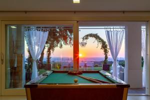 a pool table in front of a window with a view at Villa Belvedere in Bertinoro
