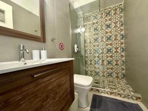 a bathroom with a sink and a toilet and a shower at The blue house Athens in Athens +42 photos