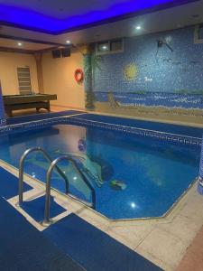 a large swimming pool with a large aquarium in the background at شاليه سهم in Al Khobar