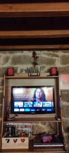 a television sitting on a shelf in a room at El Mirador del Alberche 1 in Navaluenga
