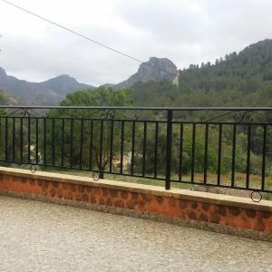 a bench with a view of a mountain at Casa Rural Puente Del Segura in Elche de la Sierra