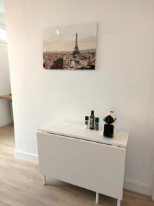 une table blanche avec une photo de la tour eiffel dans l'établissement Superbe 2 pièces rénové et calme, à Aubervilliers