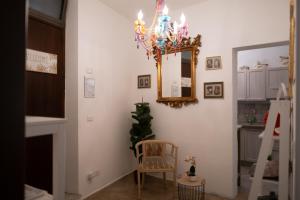 a dining room with a mirror and a chandelier at Briogna by Maravigghia Palermo in Palermo