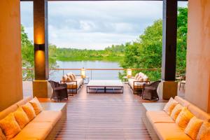 a balcony with couches and a view of a lake at Lily Pod in Panadura