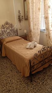 a bed with two pillows on it in a bedroom at Relais Corso Storico in Pisa