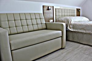 a bedroom with a couch and a bed at Willa Exotic kryty basen in Łeba +38 photos