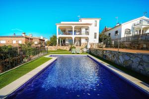 a house with a swimming pool in front of a house at Villa Mar in Teià