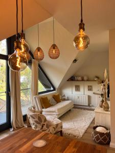 sala de estar con luces colgantes y sofá en Estelle, en Stromberg