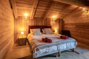 sypialnia z dużym łóżkiem w drewnianym domku w obiekcie Chalet Kala w mieście Risoul