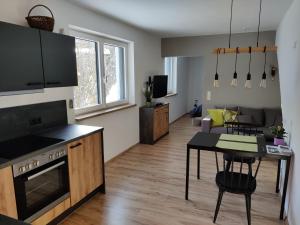 a living room with a kitchen and a dining room at Apartment am Mühlbach in Reith bei Seefeld