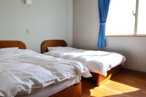 Postel nebo postele na pokoji v ubytování Hotel NALU　ホテルナル