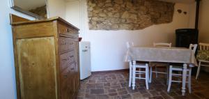 a kitchen with a table and a table and a refrigerator at Col di Lana in Rocca di Botte