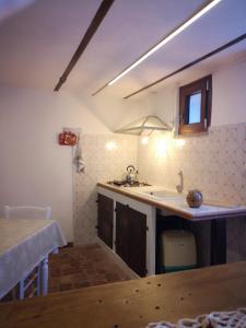 a kitchen with a sink and a counter top at Col di Lana in Rocca di Botte