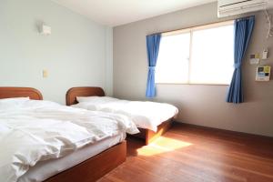 Postel nebo postele na pokoji v ubytování Hotel NALU　ホテルナル