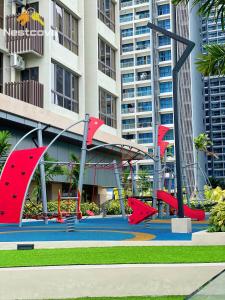 a playground in front of a large building at Mutiara Bali Residence Suites By Nestcove in Melaka