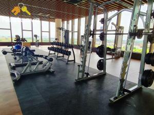 a gym with treadmills and machines in a building at Mutiara Bali Residence Suites By Nestcove in Melaka