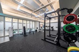 a gym with treadmills and weights in a building at KNox Hotel in Cheonan