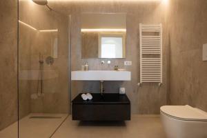 a bathroom with a sink and a shower and a toilet at Luxury Cefalù Santa Maria in Cefalù