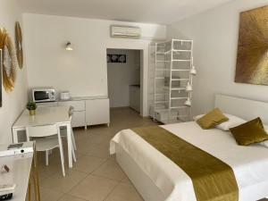 a bedroom with a bed and a table and a kitchen at Villa Katarina 2nd Floor Apartments in Dubrovnik +68 photos