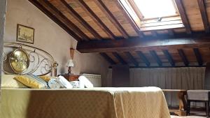 a bedroom with a bed with a table and a window at Relais Corso Storico in Pisa